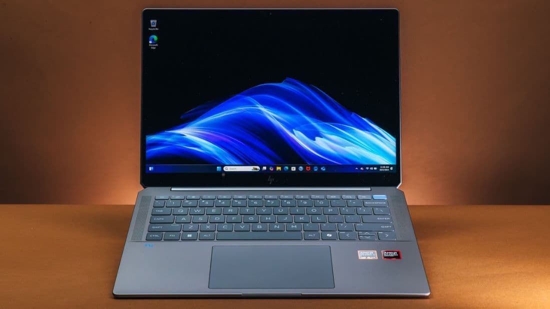 HP OmniBook Ultra 14 open on a desk, showing the keyboard and 3K OLED panel